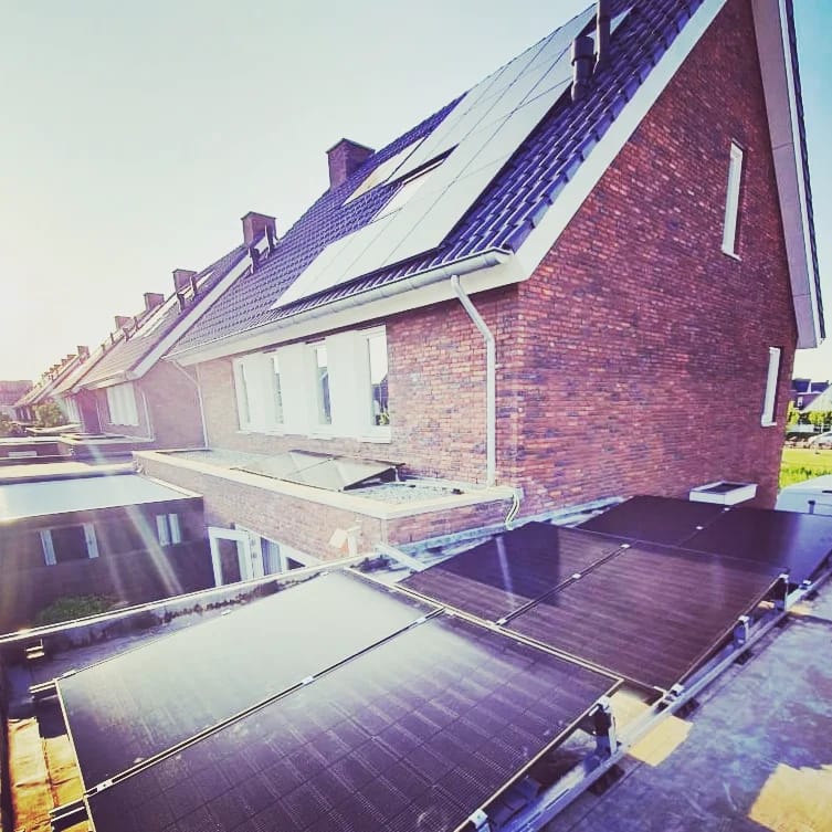 Zonnepanelen op het schuine en platte dak van een woonhuis